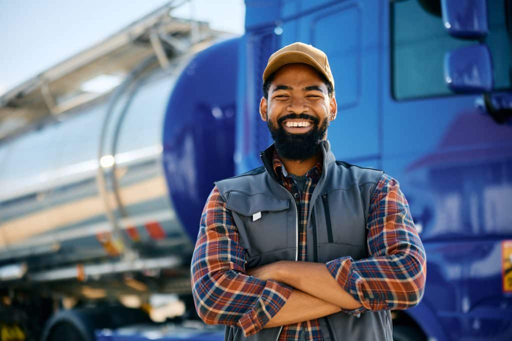Owner-operator truck driver posing with his rig